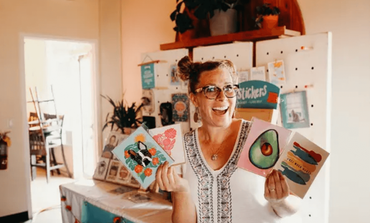 vendor holding up her art